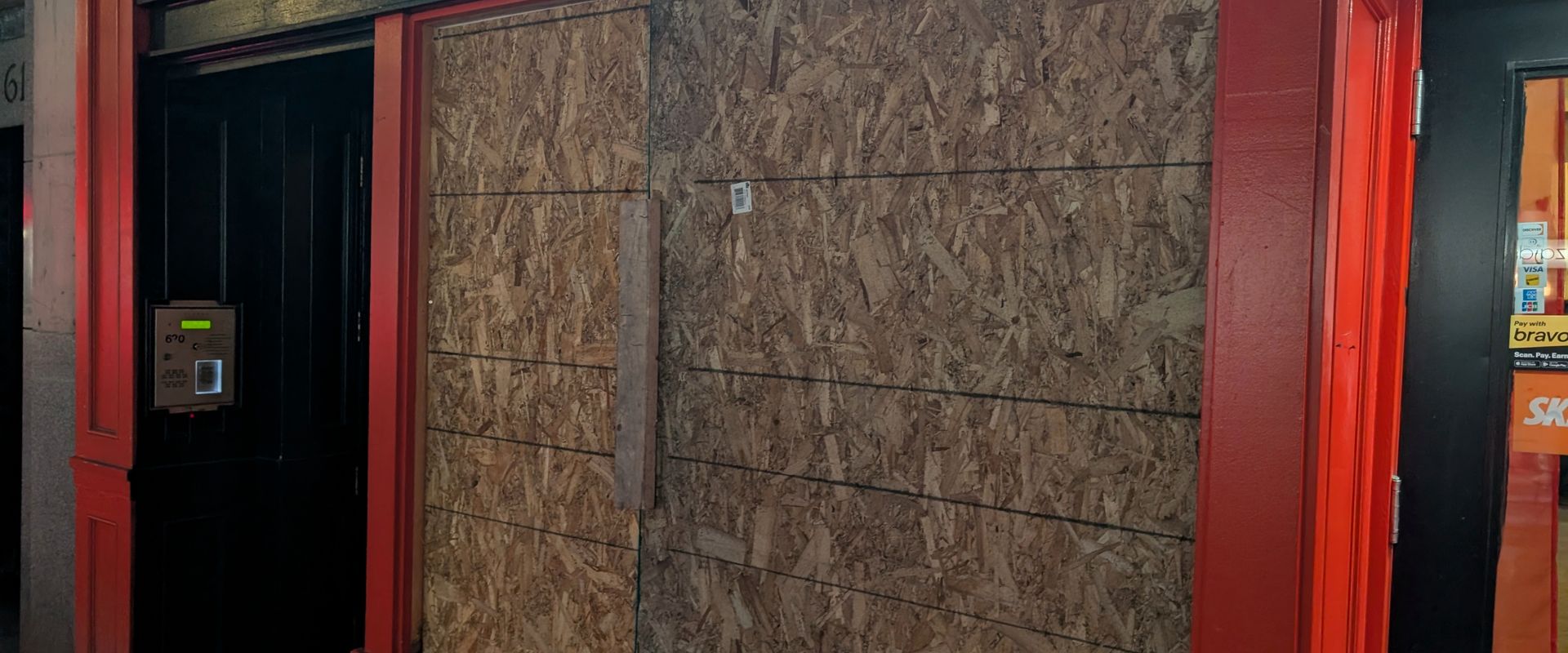 Emergency board-up of a smashed commercial window