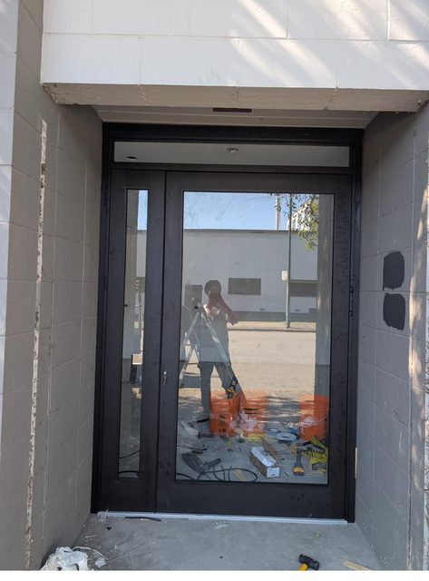 New aluminum commercial entry door and sidelite being installed in Vancouver