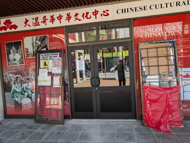 Chinatown building entrance boarded and sheeted in plastic after a break-in