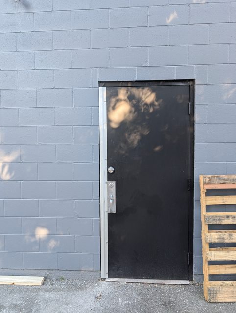 Hollow metal service door installed in a commercial block wall