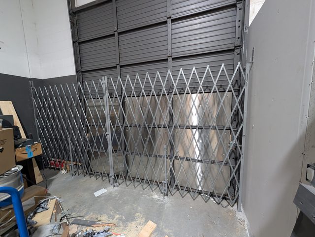 Interior scissor security gate installed during a commercial renovation