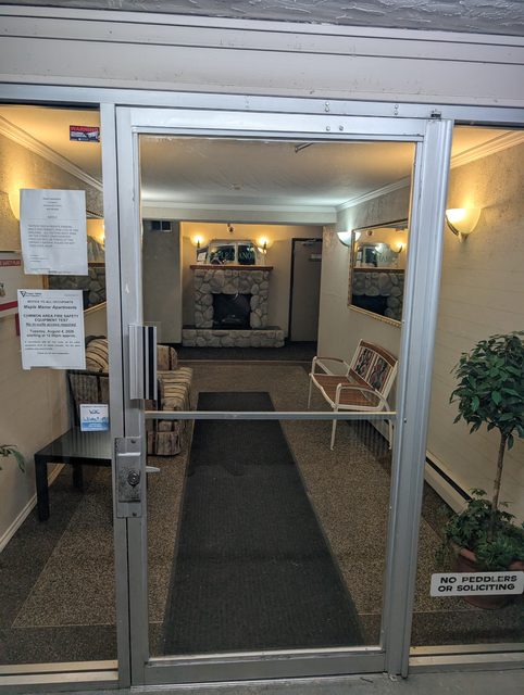 The same apartment lobby door with clear new glass installed