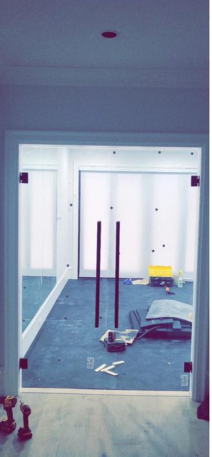 Frameless interior glass double doors fitted between two rooms