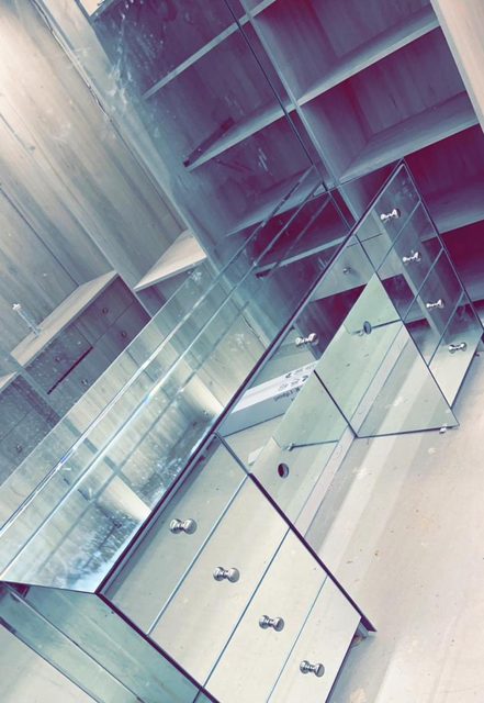 Custom cut mirror panels ready for installation on a Surrey project