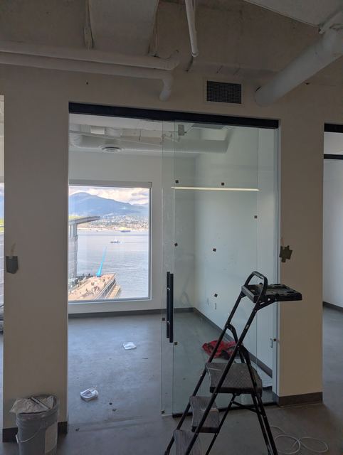 Frameless office glass door with matte black hardware