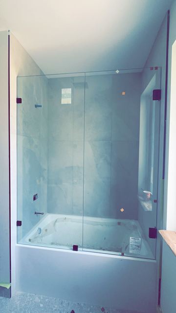 Large frameless hinged shower door