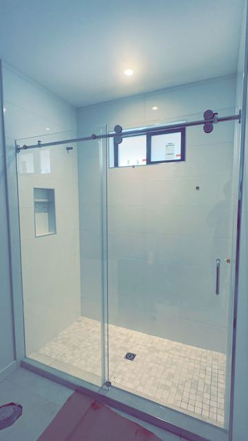Large sliding shower door with marble surround