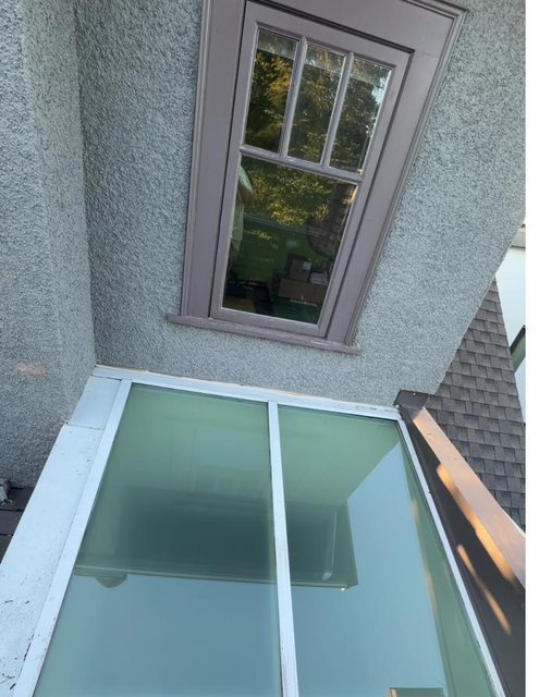 Sloped skylight glazing over a rear deck on a Vancouver home