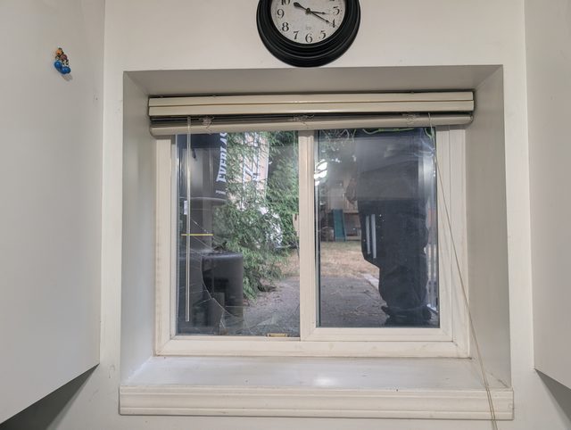 Small interior window with a roller shutter before glass replacement