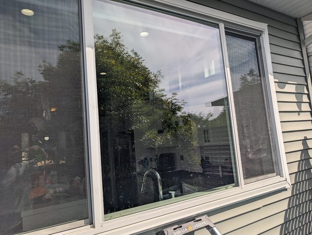 Large replacement window seen from outside on a sided home