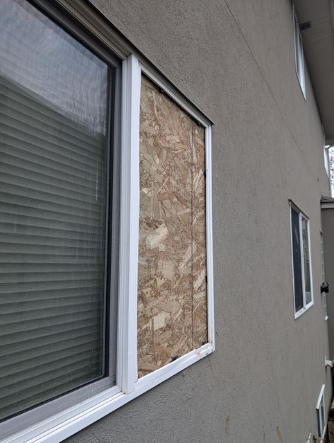 Residential window boarded up awaiting replacement