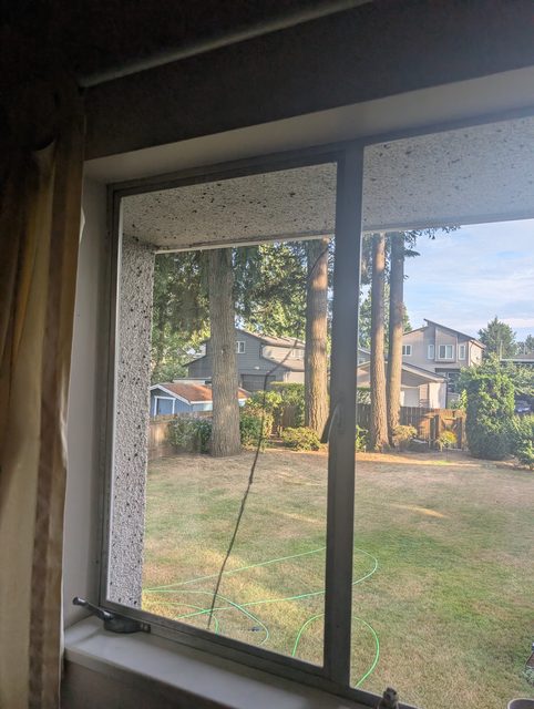 Slider window looking onto a back garden after glass replacement