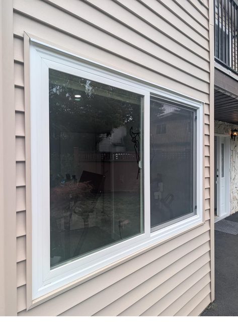 New vinyl slider window glass on the side of a Lower Mainland home